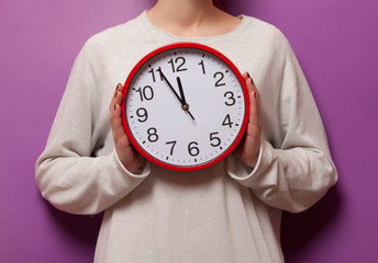 Woman holding clock