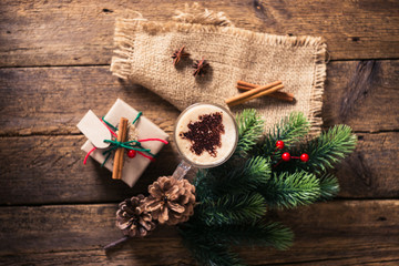 Cocoa on a wooden table with Christmas decorations, branches