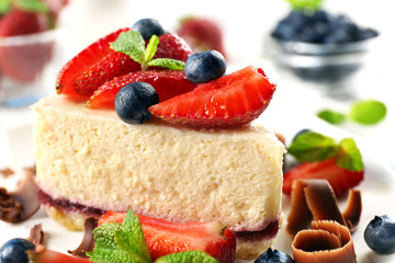 Delicious cheesecake with berries on table close up