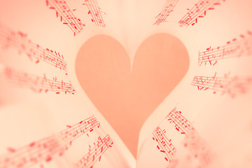 Book pages curved into heart shape close up