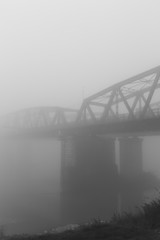 old iron bridge over wrapped in a mysterious fog