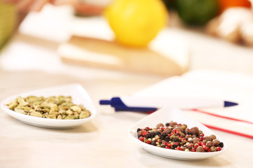 Variety of spices in ceramic containers on the kitchen table