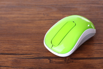 Wireless computer mouse on wooden background
