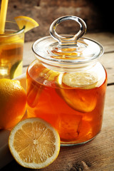 Iced tea with lemon on wooden background