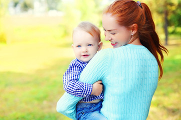 Portrait happy smiling mother and son child outdoors in park