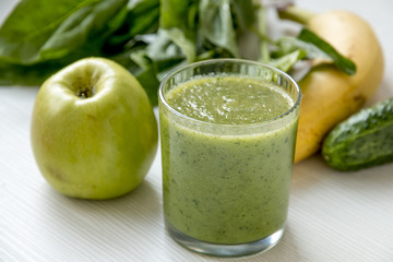 Green Smoothie Close up. Over White Wooden Background.