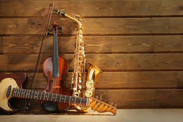 Musical instruments on wooden background - obrazy, fototapety, plakaty