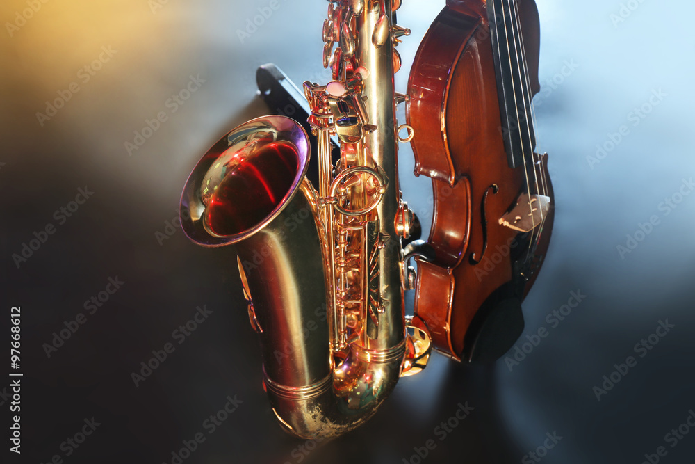 Sticker beautiful golden saxophone with violin on a scene, close up