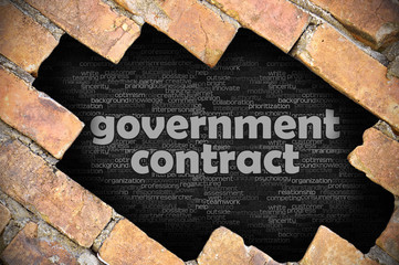 Hole in the brick wall with word government contract - 97668831