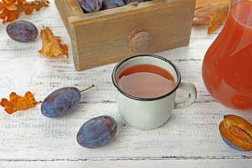 Plum Juice in jar and mug with fresh fruits