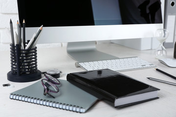 Stylish workplace with computer and stationery
