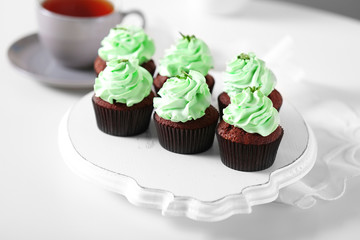 Beautiful chocolate cupcakes and cup of tea,  on table