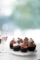 Tasting of wine and chocolate cupcakes, close up