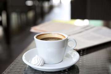 Cup of tasty coffee and zephyr in cafe
