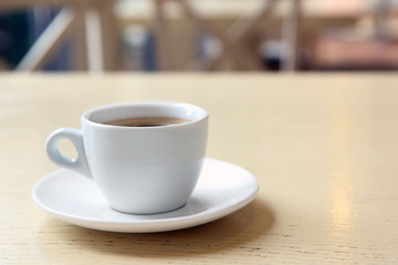 Cup of tasty coffee on cafe background