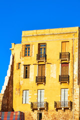 Facade building with windows and balconies in Chania on the island of Crete.