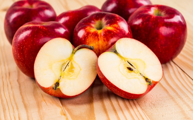 Ripe red apples on wooden background