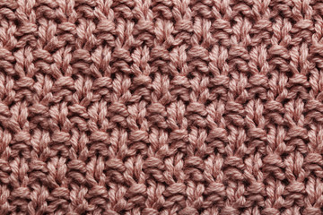 Knitted woolen fabric background, close up
