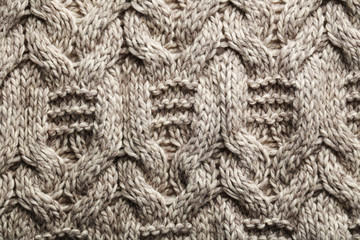 Knitted woolen fabric background, close up