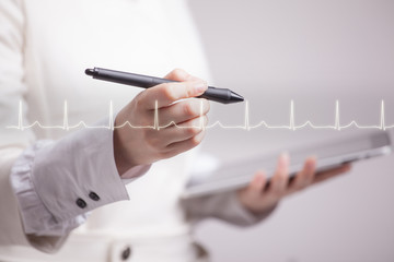 doctor woman drawing cardiogram