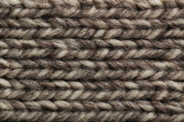 Knitted woolen fabric background, close up