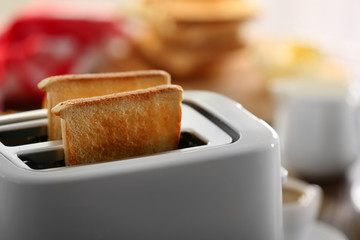 A couple of crusty toasts in the toaster, close-up