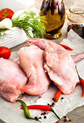 Raw rabbit legs, vegetables and seasoning