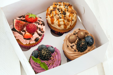 Set of different cupcakes decorated with fresh berries