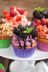 Set of different delicious cupcakes