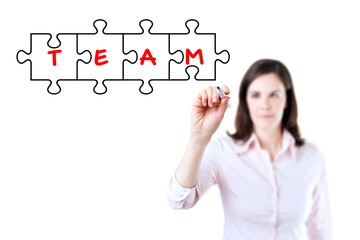 Businesswoman drawing a Teamwork Puzzle Concept on the virtual screen. Isolated on white. 
