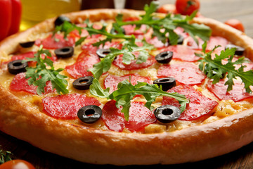 Tasty pizza with salami background, close up