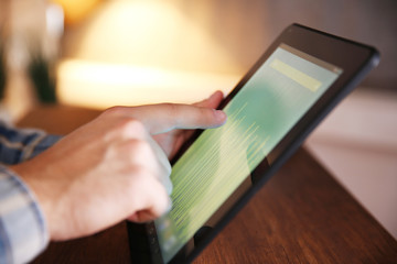 Young man using his tablet-pc, close up