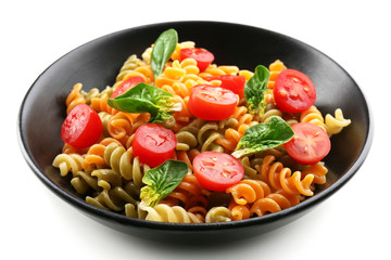 Delicious macaroni dish in black bowl isolated on white background