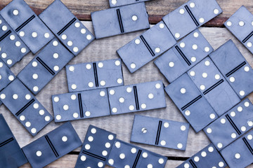 old dominoes lies on a wooden surface.background