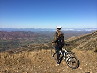 girl cycling on a bike in the mountains