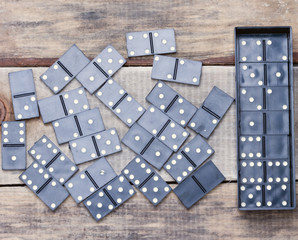 old dominoes lies on a wooden surface. background.toned
