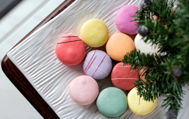 Traditional french macaroons under a little christmas tree still life