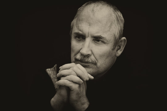 Sepia toned image of a thoughtful Caucasian man