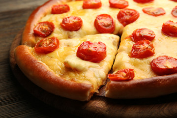 Pizza Margherita and removed slice on table, close-up