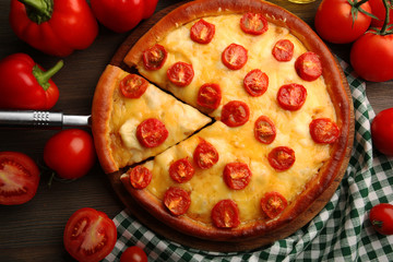 Pizza Margherita, removed slice and vegetables, close-up