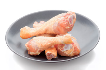 raw chicken thighs in dark porcelain dish