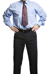 Businessman in blue shirt stands with hands on the waist