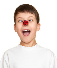 boy with ladybug on face, teenager fun portrait closeup