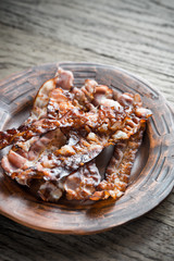 Fried bacon strips on the plate