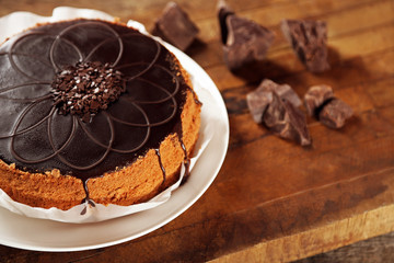 Tasty chocolate cake on wooden background