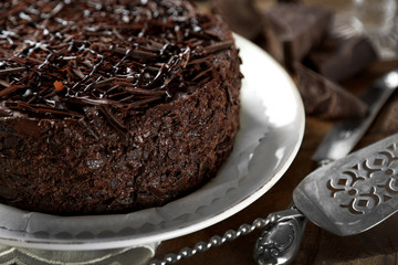 Tasty chocolate cake on wooden background