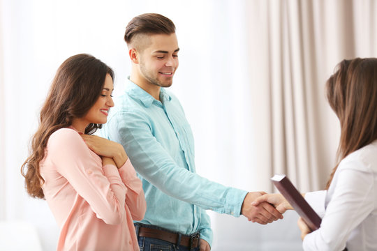 Man shaking hands with estate agent in new home