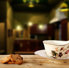Chocolate Cookies and tea put on Wooden with Kitchen Background.