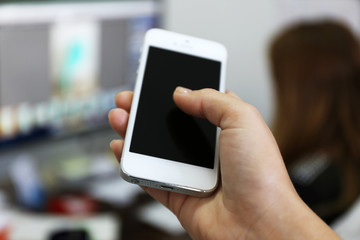 Woman holding smartphone indoors