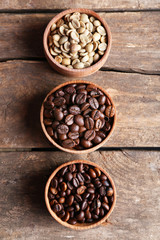 Collection of coffee beans on old wooden table, close up